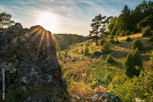Rock hillside of Franconian Switzerland, sunset on summer evening