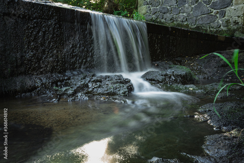 blurred image of a small river waterfall close-up  long exposure