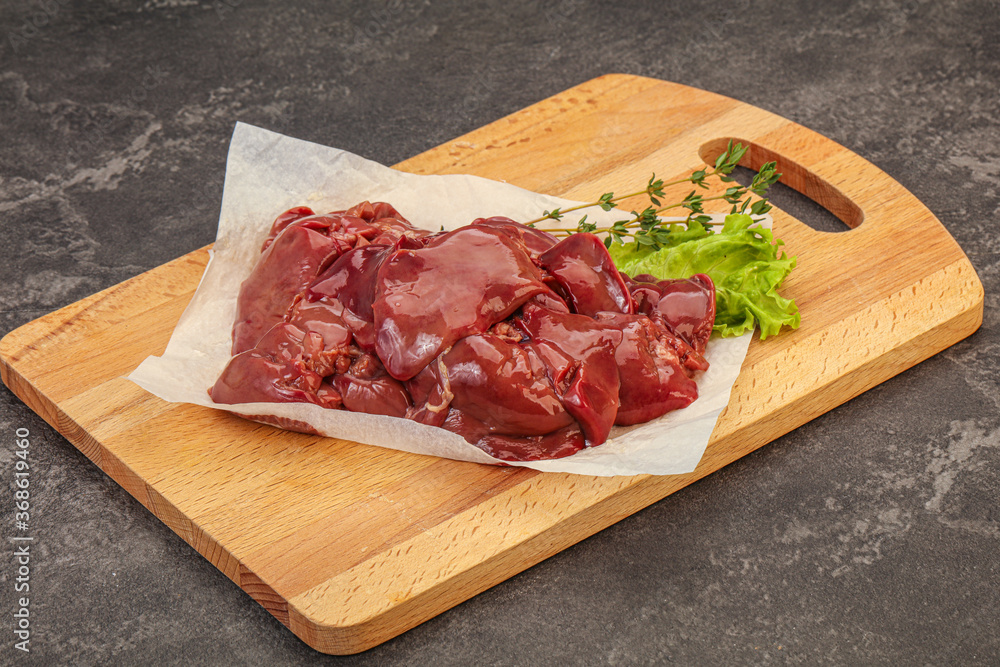 Raw chicken liver over board