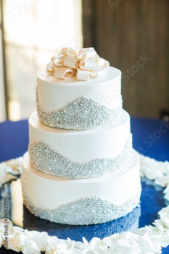 elegant white tiered wedding cake with silver decor