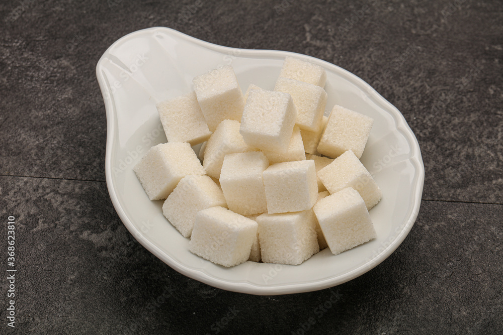 Refined white sugar cubs in the bowl Refined white sugar cubs in the bowl