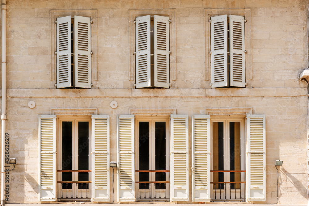 Obraz premium Typical historic building with shutters in historic center of Avignon, Provence