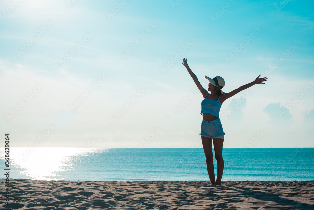 Full Length Of Woman With Arms Outstretched Standing On Shore At Beach Full Length Of Woman With Arms Outstretched Standing On Shore At Beach