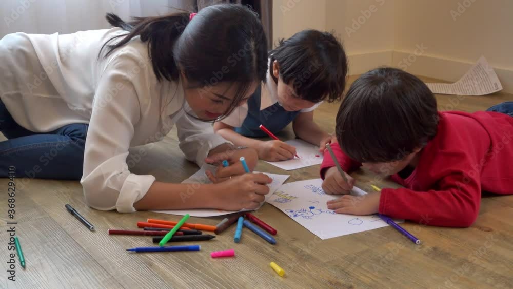 Asian happy family child kids boy kindergarten drawing or painting art and education learning together beautiful parent mom teacher at interior room home Asian happy family child kids boy kindergarten drawing or painting art and education learning together beautiful parent mom teacher at interior room home