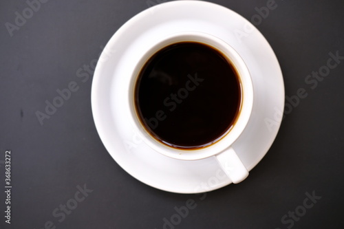 coffee cup and coffee beans on old wood table background, space for text