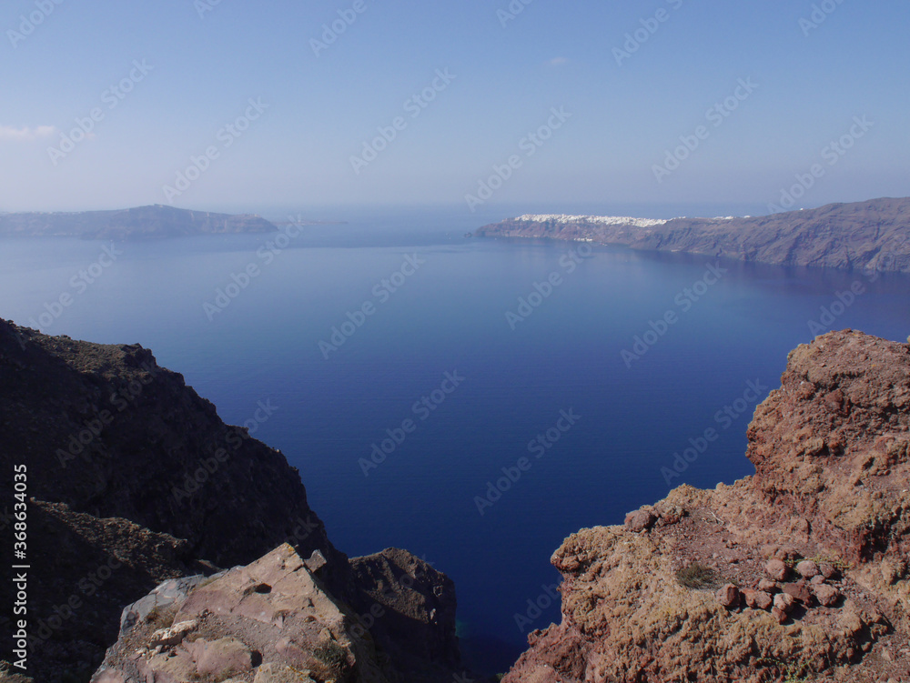Panoramic view of mountains, sea and nature from Fira town, Santorini island Greece. View of the caldera and ships in the bay.