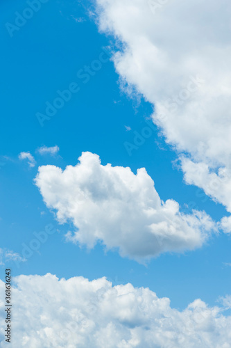 White clouds with blue sky. Vertical shot.
