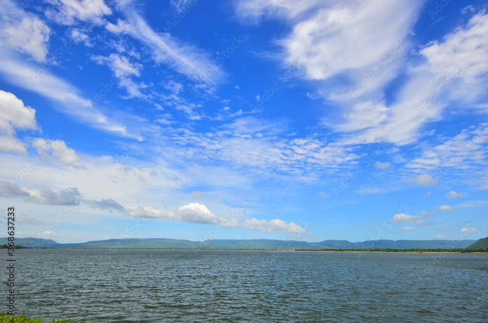 Beautiful white clouds in blue sky over the lake