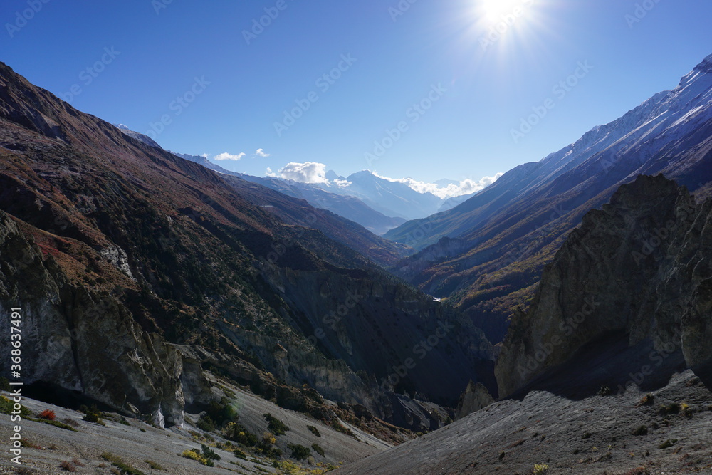 Steep slopes and landslide area with views of mountains and v shaped valley on the way to Tilicho lake in Manang, Nepal.