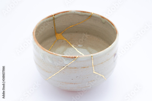 Antique kintsugi, tea pottery set chawan bowl restored with gold. photo