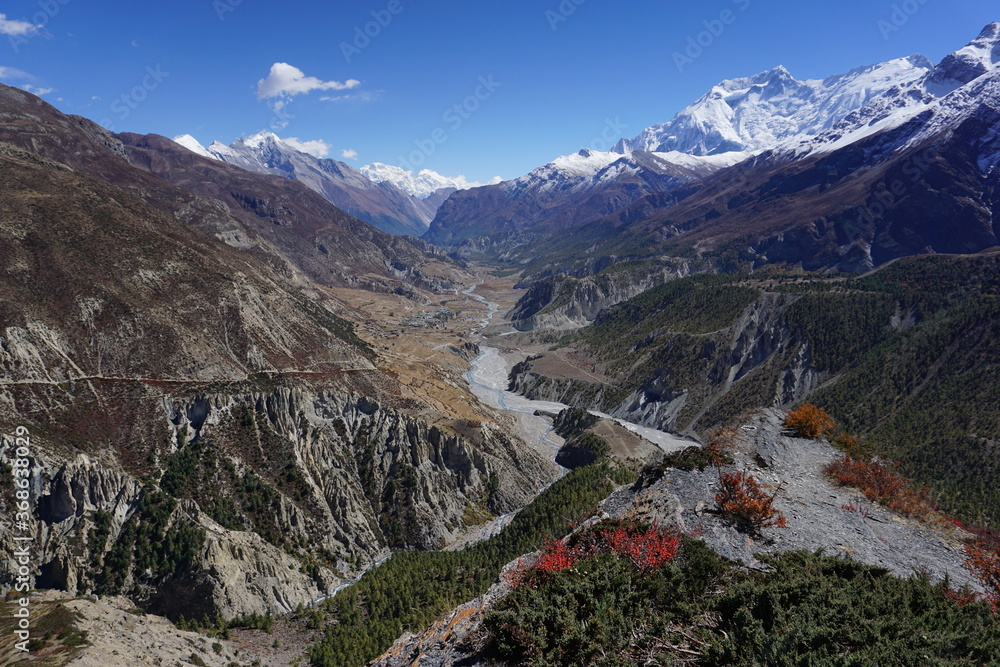 View of Manang valley and Annapurna mountain range from a viewpoint on Tilicho-Yak Kharka trekking trail in Annapurna Circuit, Nepal.