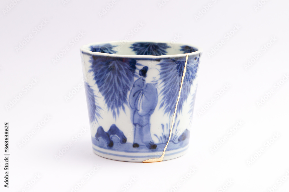 Antique Japanese kintsugi soba cup restored with gold. Antique Kintsukuroi ceramic. Antique Japanese kintsugi soba cup restored with gold. Antique Kintsukuroi ceramic.