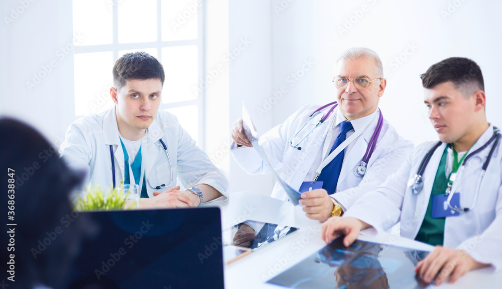 Medical team sitting and discussing at table Medical team sitting and discussing at table