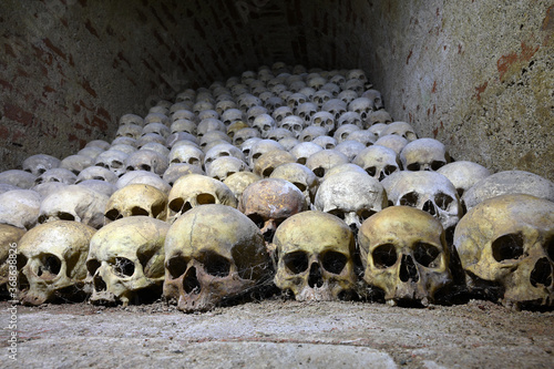 Bild auf Leinwand skulls human catacombs religious theme
