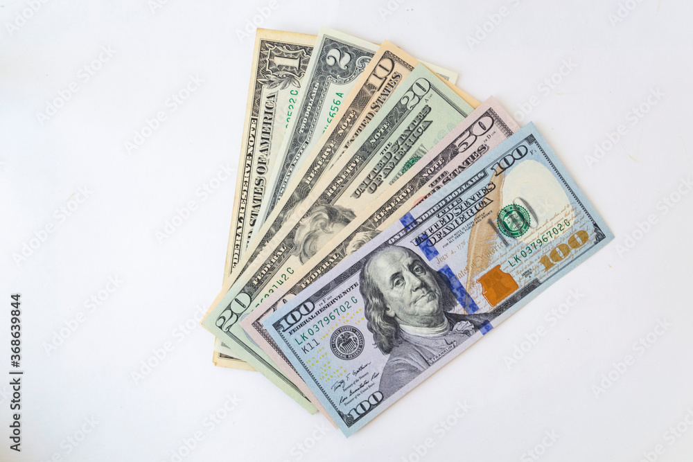 Stack of money American dollar bills on a white background. The concept of buying for dollars Stack of money American dollar bills on a white background. The concept of buying for dollars