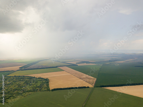 Aerila drone view. Summer rain over agricultural fields in Ukraine. © Sergey