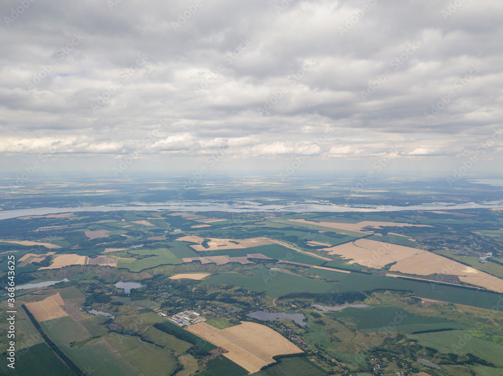 Rain clouds over agricultural fields in Ukraine, aerial view.
