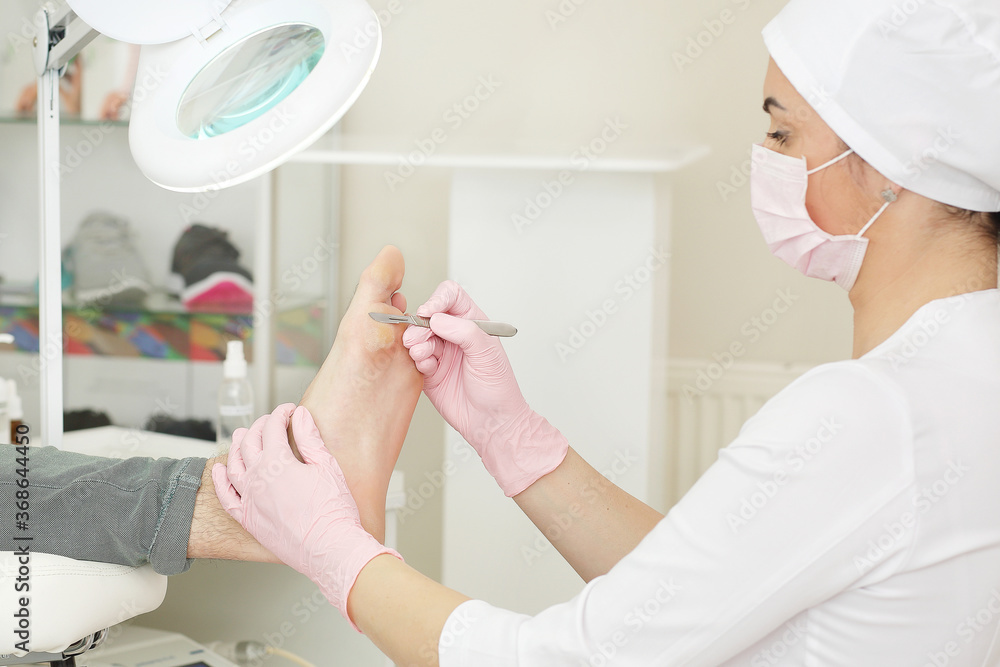 Professional pedicure using dieffenbach scalpel.Patient visiting