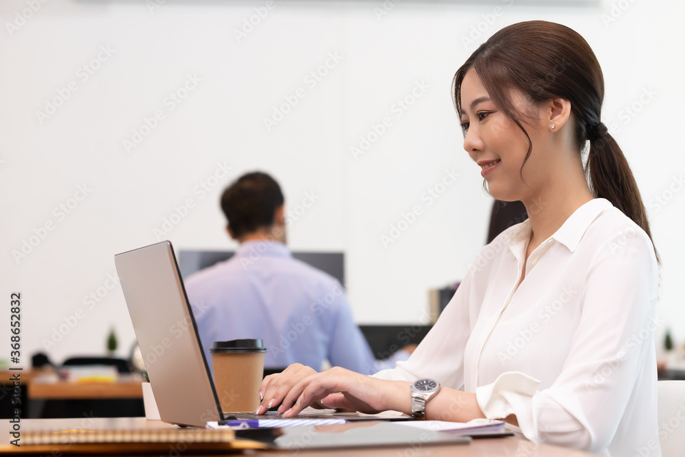 Business asian woman happy working job on laptop in office. Business asian woman happy working job on laptop in office.