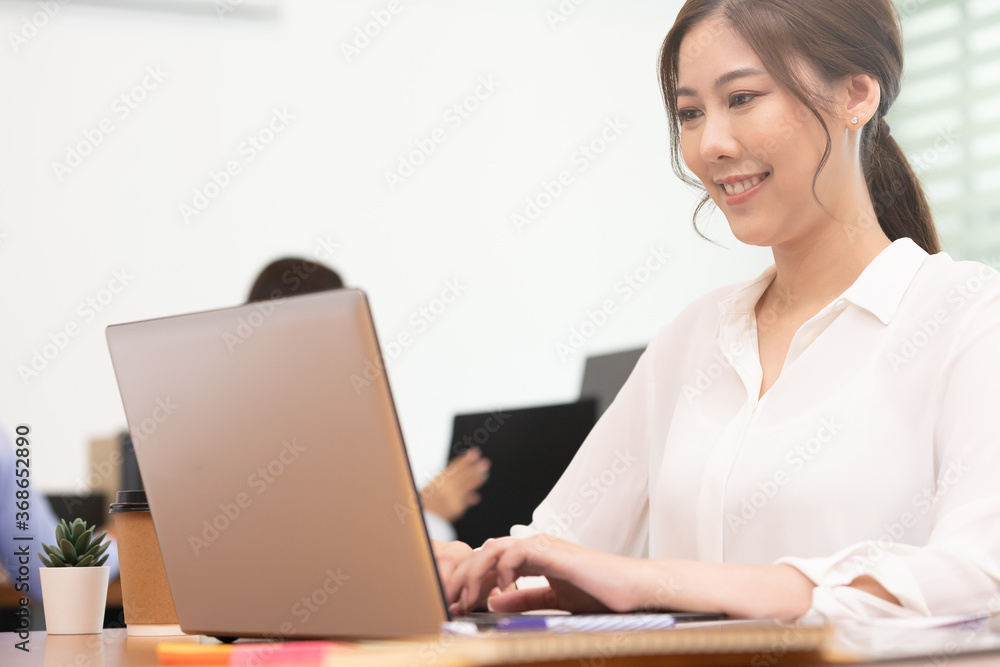Business asian woman happy working job on laptop in office. Business asian woman happy working job on laptop in office.