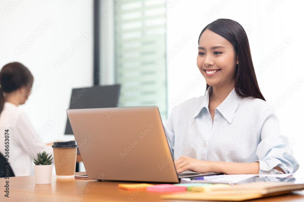 Business asian woman happy working job on laptop in office. Business asian woman happy working job on laptop in office.