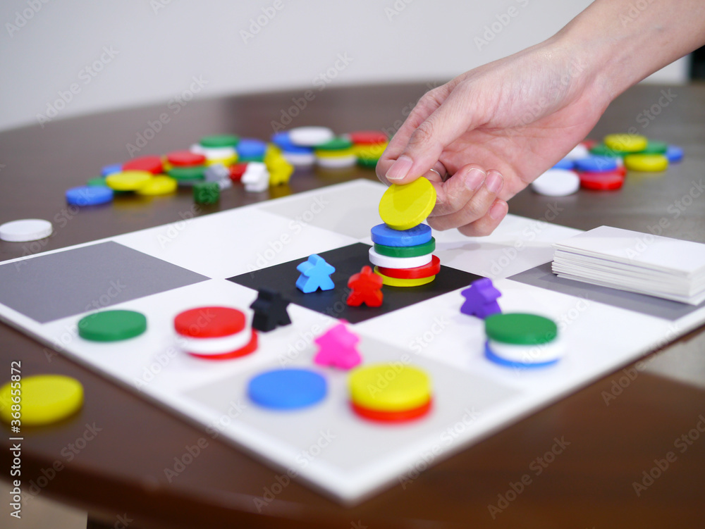 people playing fun board game on wooden table top selected focus people playing fun board game on wooden table top selected focus