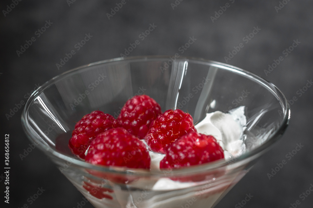 Food photo. Berry dessert. Sour cream with raspberries. Glamorous raspberry. Raspberry with cream in a glass goblet. Healthy eating. Summer foods and vitamins. Healthy breakfast and snack. Food photo. Berry dessert. Sour cream with raspberries. Glamorous raspberry. Raspberry with cream in a glass goblet. Healthy eating. Summer foods and vitamins. Healthy breakfast and snack.