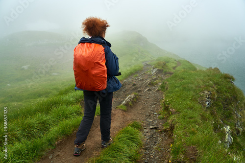 Lady hiker on a trail in the mountains © Xalanx