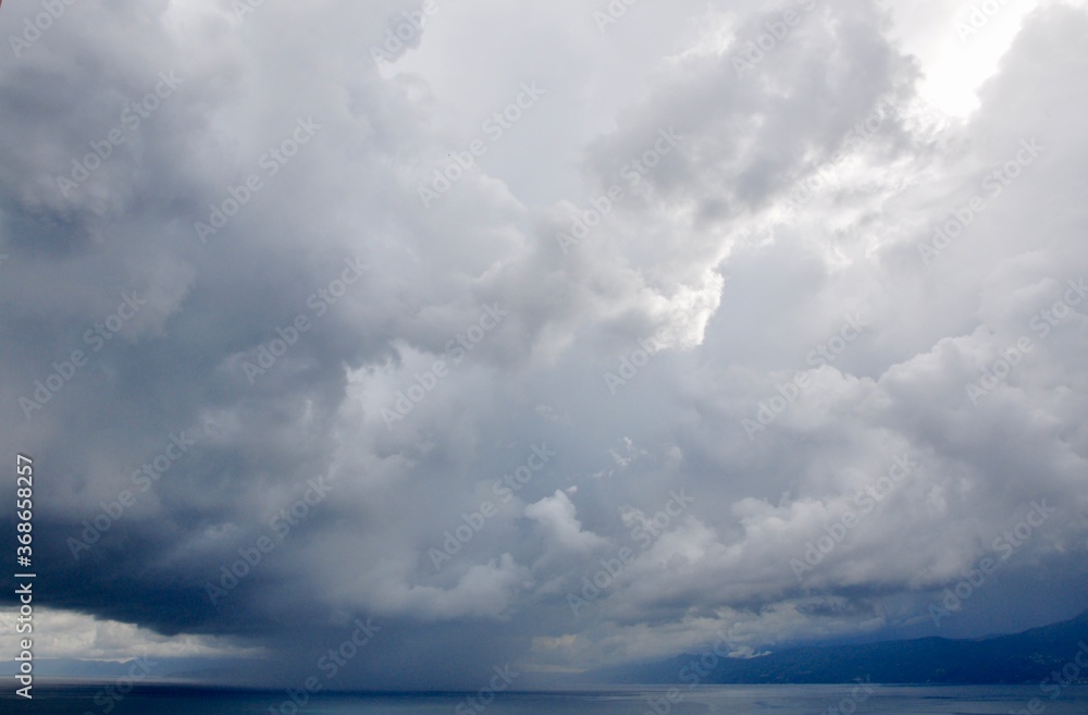 Dramatic sky during rain storm on the sea. clouds over the sea Dramatic sky during rain storm on the sea. clouds over the sea
