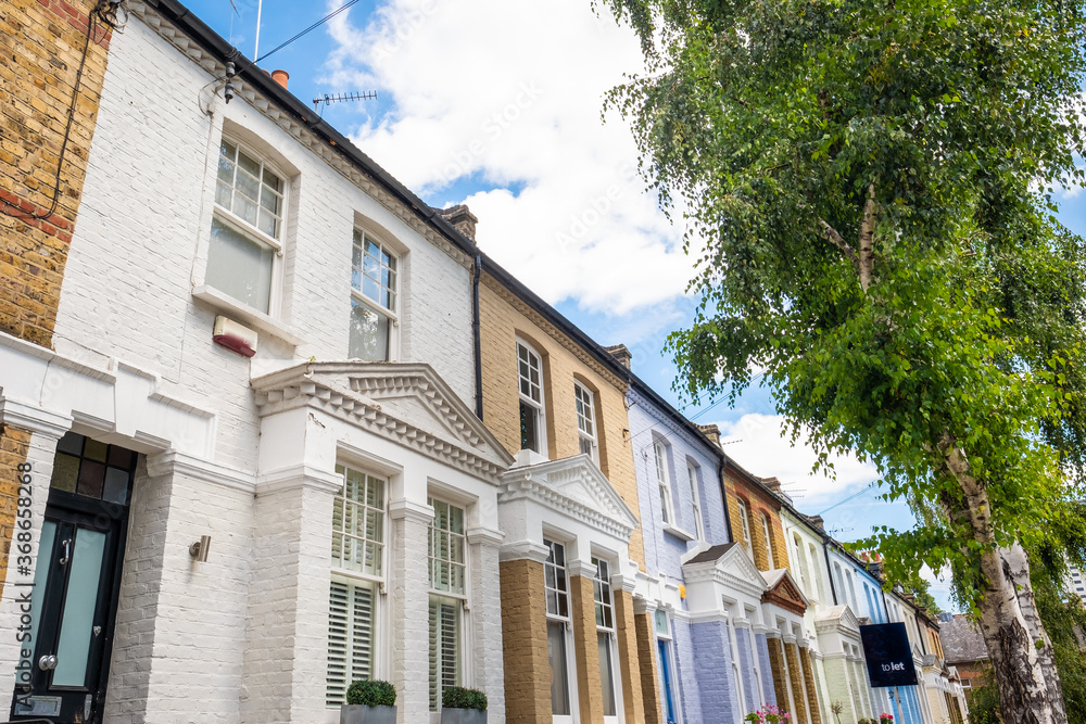 Naklejka premium Attractive residential street of large terraced houses in Kensington & Chelsea borough of London 