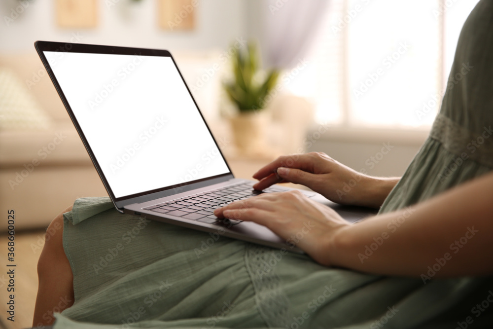 Naklejka premium Woman using laptop at home, closeup. Space for design