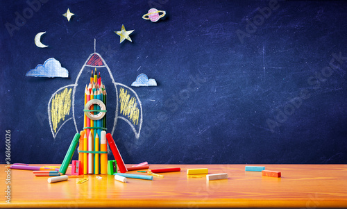 Startup Concept - Rocket Sketch On Blackboard With Colorful Pencils - Back To School