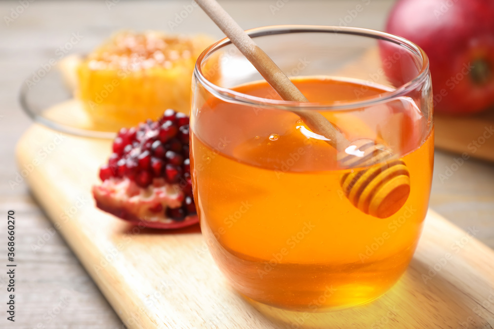 Honey, apples and pomegranate on table, closeup. Rosh Hashanah holiday Honey, apples and pomegranate on table, closeup. Rosh Hashanah holiday
