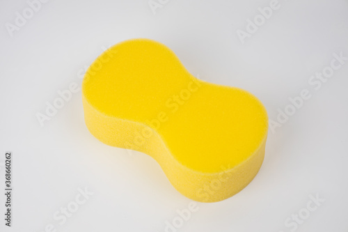 Sponge on white background. Yellow household cleaning sponge. photo