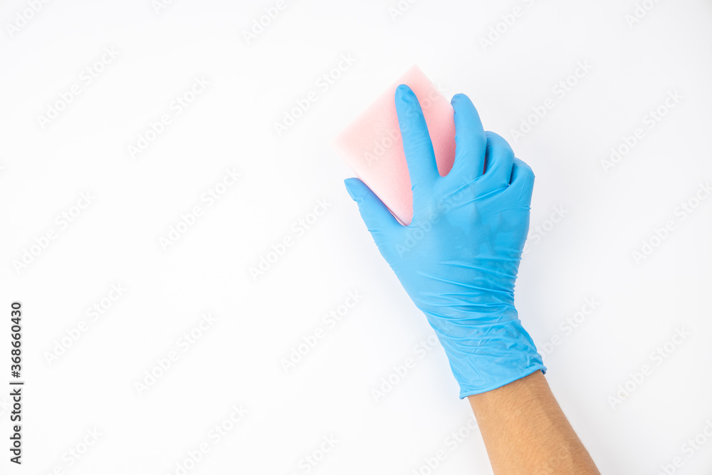 Obraz premium Sponge and spray for cleaning in female hand. Hand in a latex glove isolated on white. A hand in a glove holds a sponge and spray cleaning.