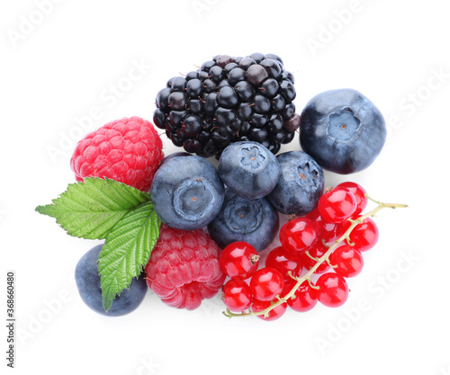 Pile of different ripe tasty berries with green leaves isolated on white, top view