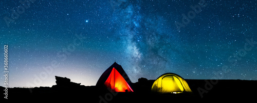 Wallpaper Mural Tents glowing under the milky way at night. Camping in the mountains under the starry magical sky. Camping and wild life concept. Real outdoor adventure. Torontodigital.ca