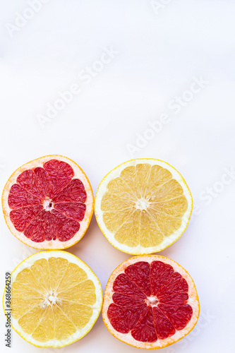 Halves of white and red grapefruit on a white background