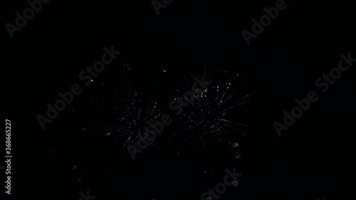 festive shining firework with bokeh in a black night sky. glowing fireworks show. Independent Day, New year fireworks celebration. multi colored fireworks in night sky. colorful night explosion
