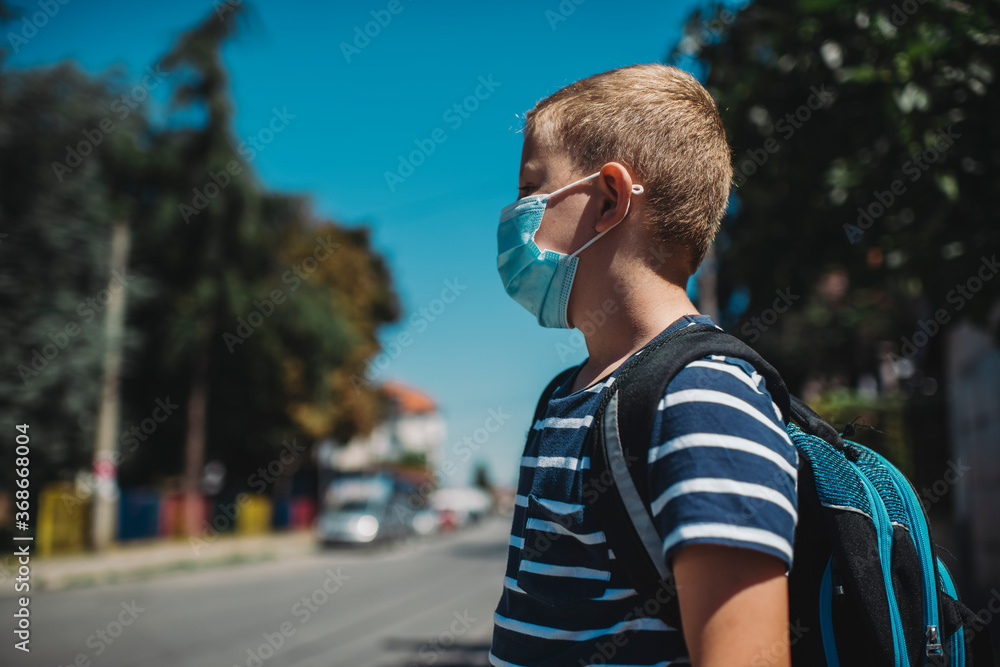 Boy going back to school after epidemic, Boy wearing a protective face mask