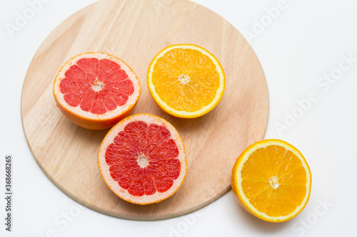 cut into sticks grapefruit and orange on a wooden Board