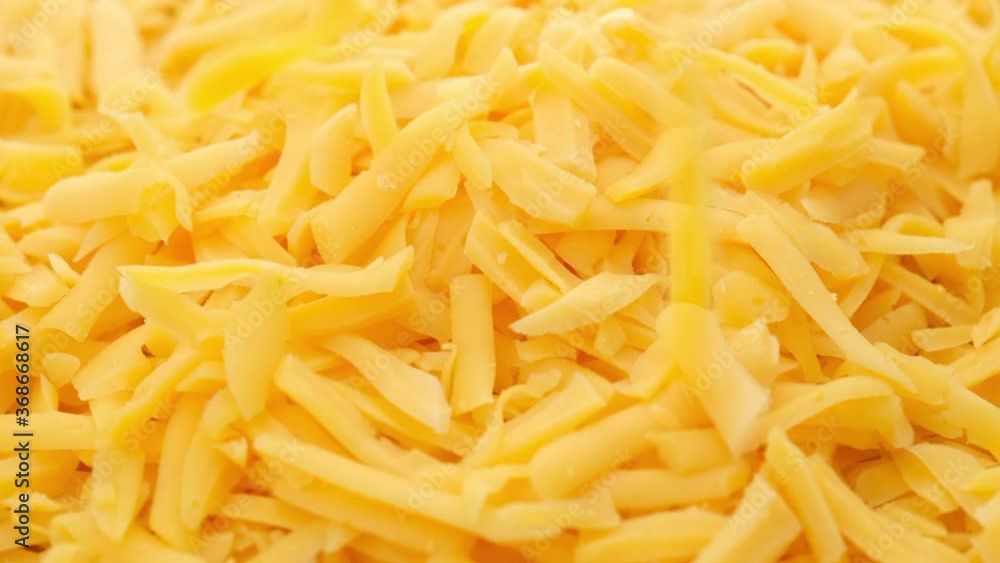 grated cheddar cheese rotating top view grated cheddar cheese rotating top view