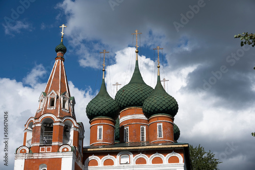 white stone old buildings with golden domes against the blue sky