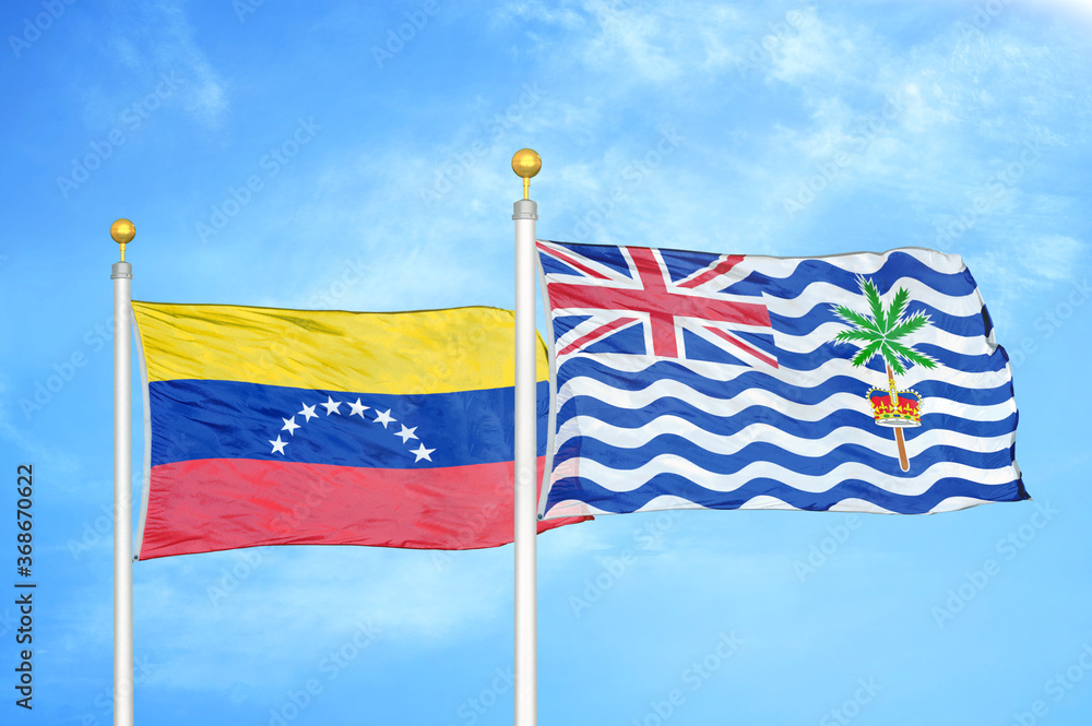 Venezuela and British Indian Territory two flags on flagpoles and blue sky Venezuela and British Indian Territory two flags on flagpoles and blue sky