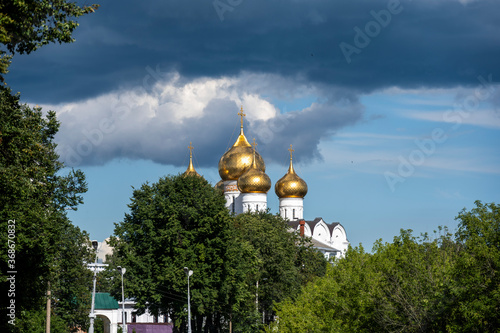 white stone old buildings with golden domes against the blue sky