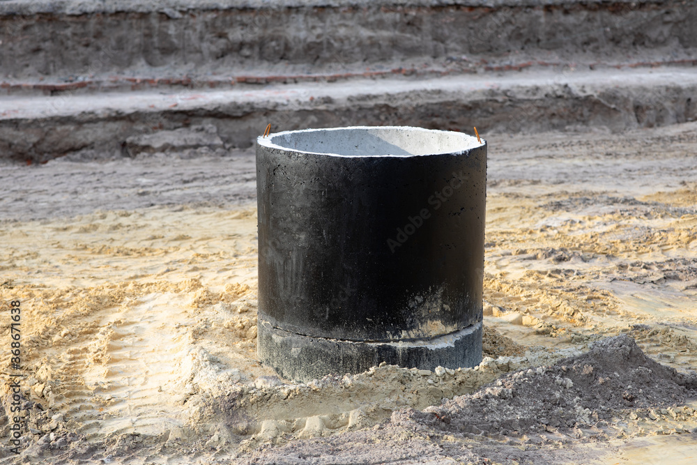 Large black concrete well for plumbing at a construction area Large black concrete well for plumbing at a construction area