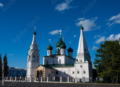 white stone old buildings with golden domes against the blue sky