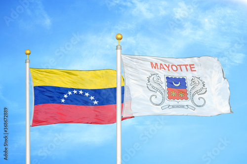 Venezuela and Mayotte two flags on flagpoles and blue sky