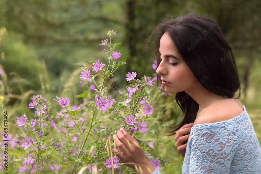 Pretty woman in lilac flowers Pretty woman in lilac flowers