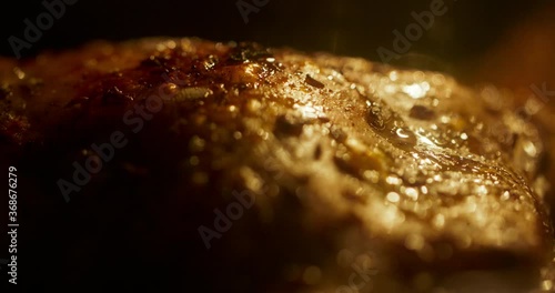 Chicken getting grilled. Extreme close up shot of chicken legs getting roated in oven. Preparation of fast food. Unhealthy food with trans fats 4k footage photo